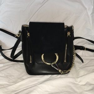 Small leather backpack in the style of Chloe Faye